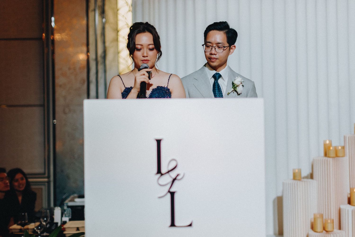 Modern wedding venue with white walls and elegant gold decor elements.