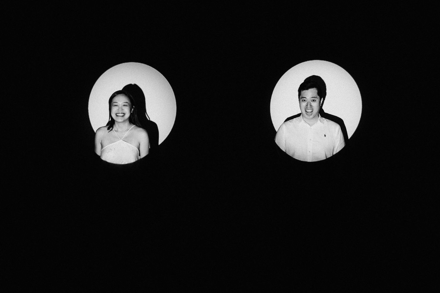 Black and white artistic portrait composition showing two circular headshots against dark background.