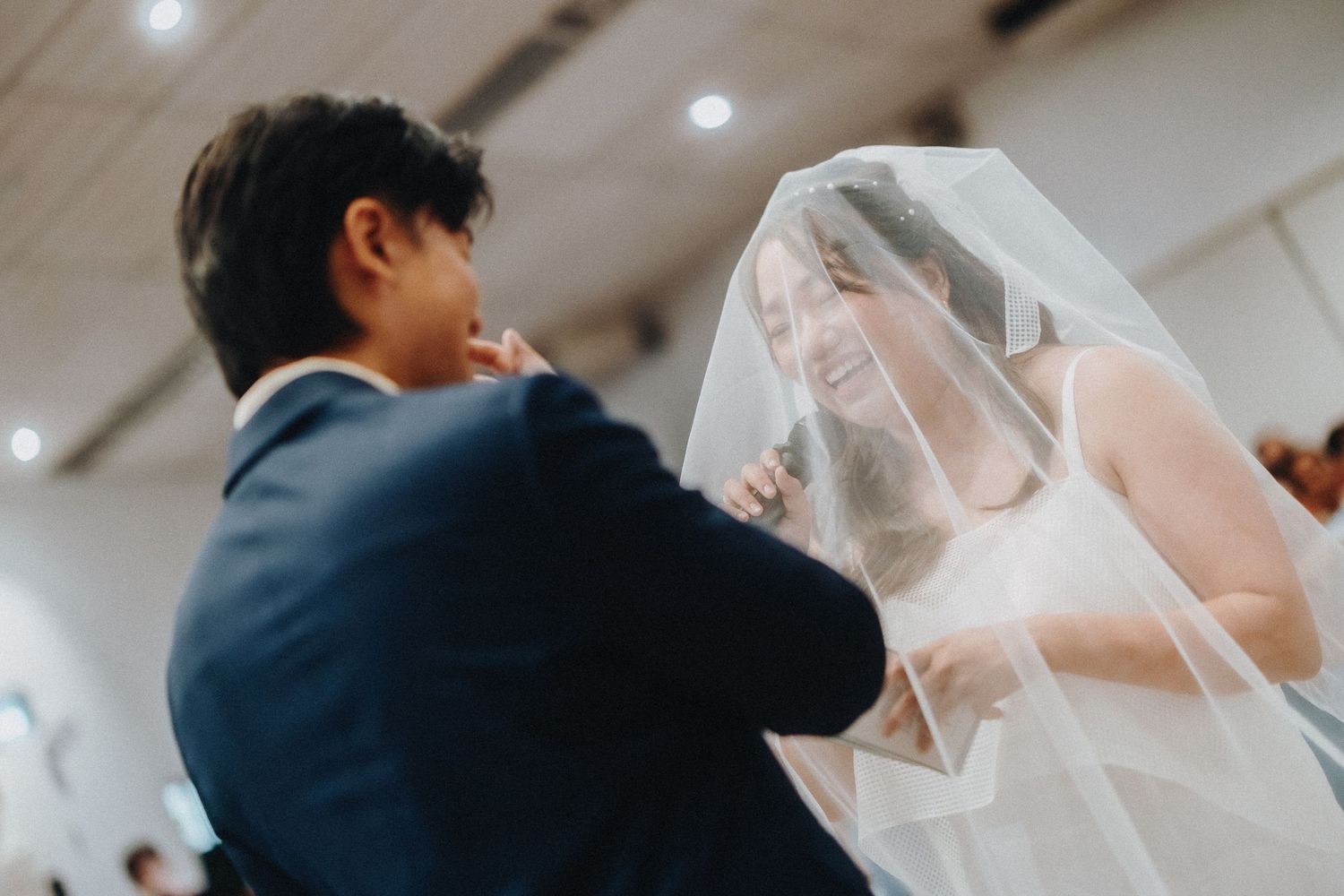 Intimate wedding ceremony moments captured under soft lighting.