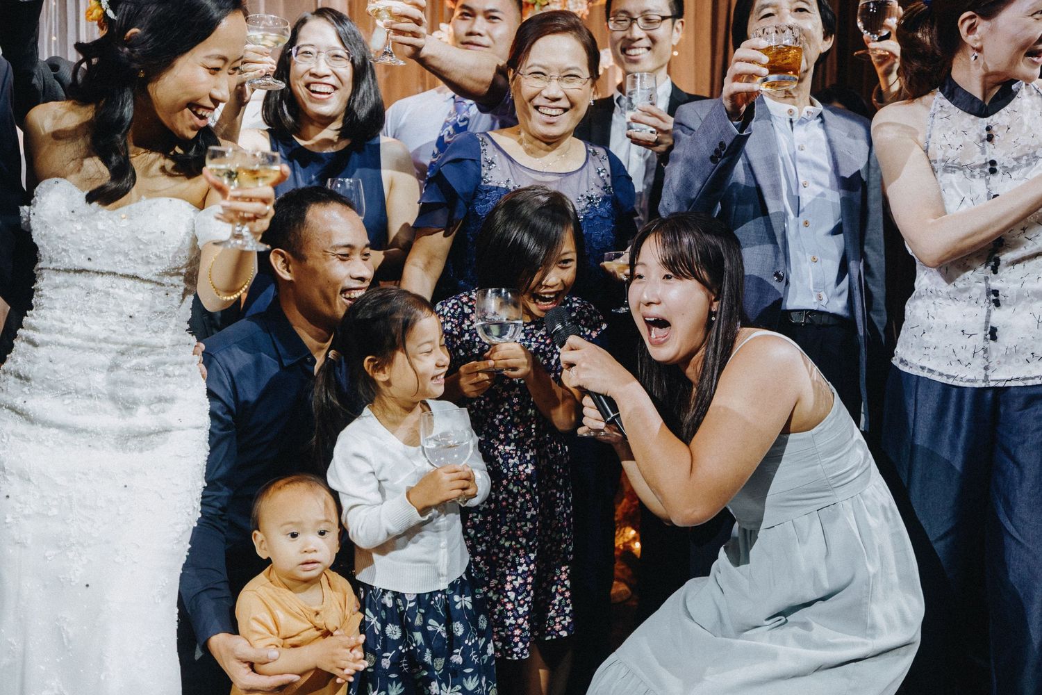 Wedding guests celebrating with animated expressions and gestures.