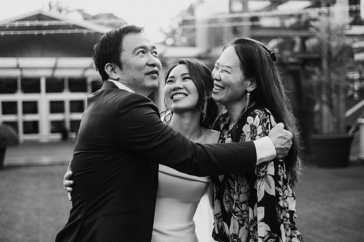 A black and white photo series capturing joyful reactions and candid moments at an outdoor gathering.