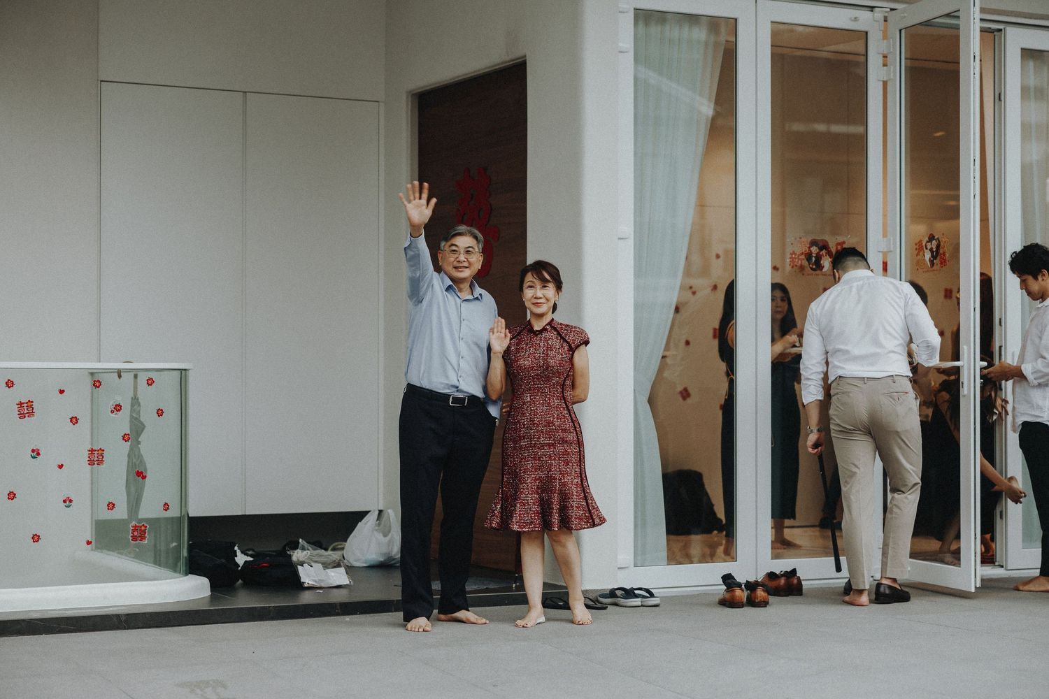 Guests waiting outside a modern white building for a wedding ceremony.