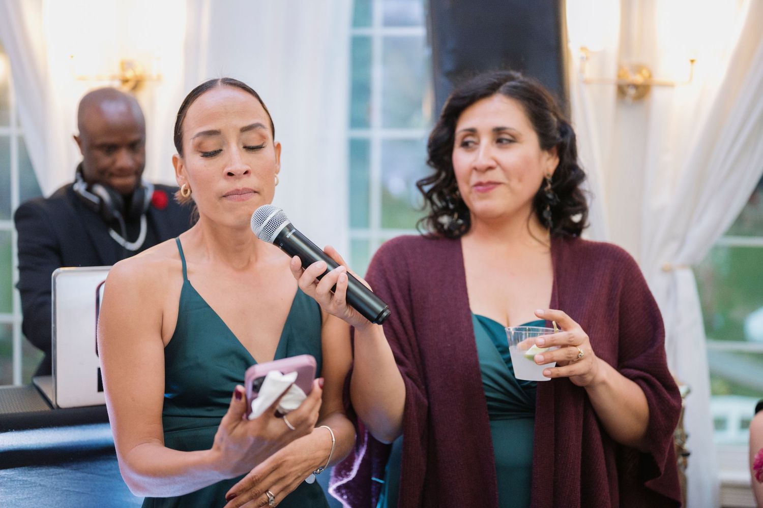 A friend reading a speech from their phone at a wedding
