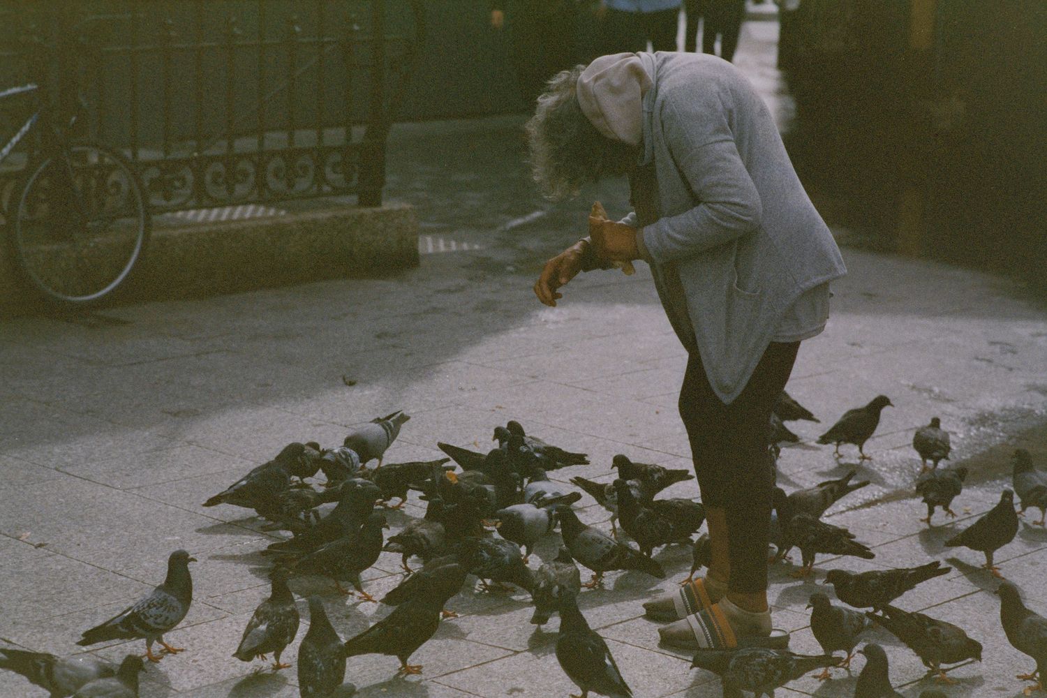 A women feeding pigeons in Paris, France