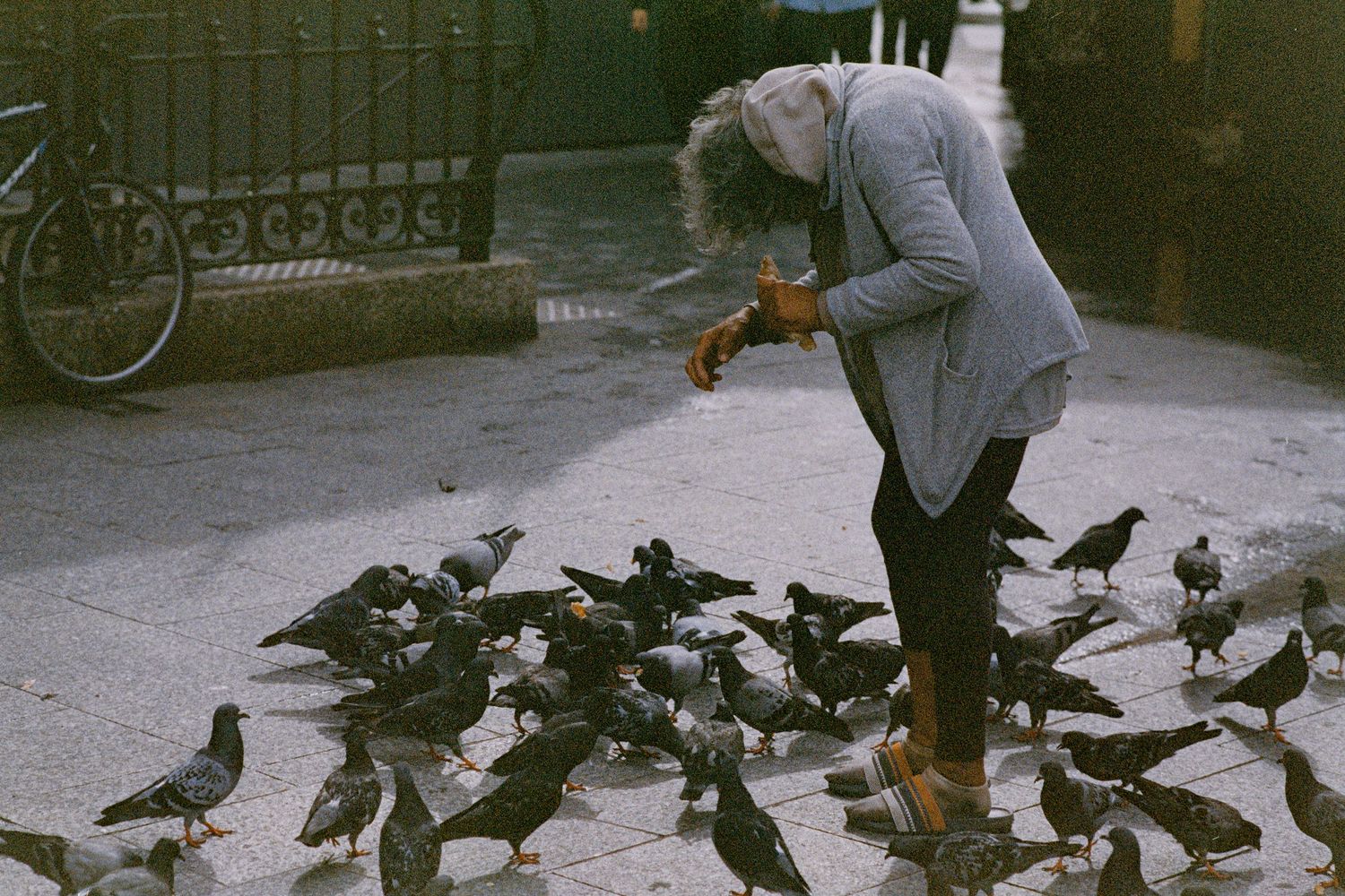 A women feeding pigeons in Paris, France