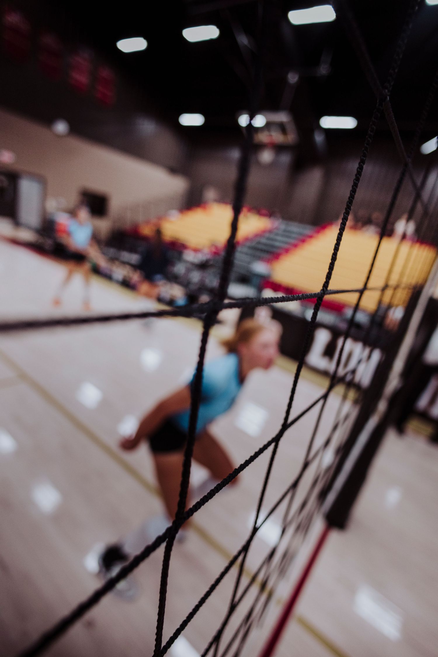 Motion-blurred sequence of volleyball players practicing in an indoor court — dynamic sports photo byDaviel.com in Tulsa