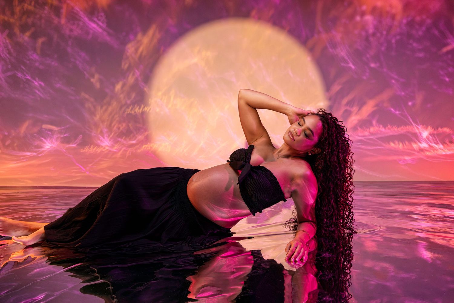 Creative maternity portrait photography session in Darwin studio featuring artistic sunset backdrop captured by Julie Françoise Imagery