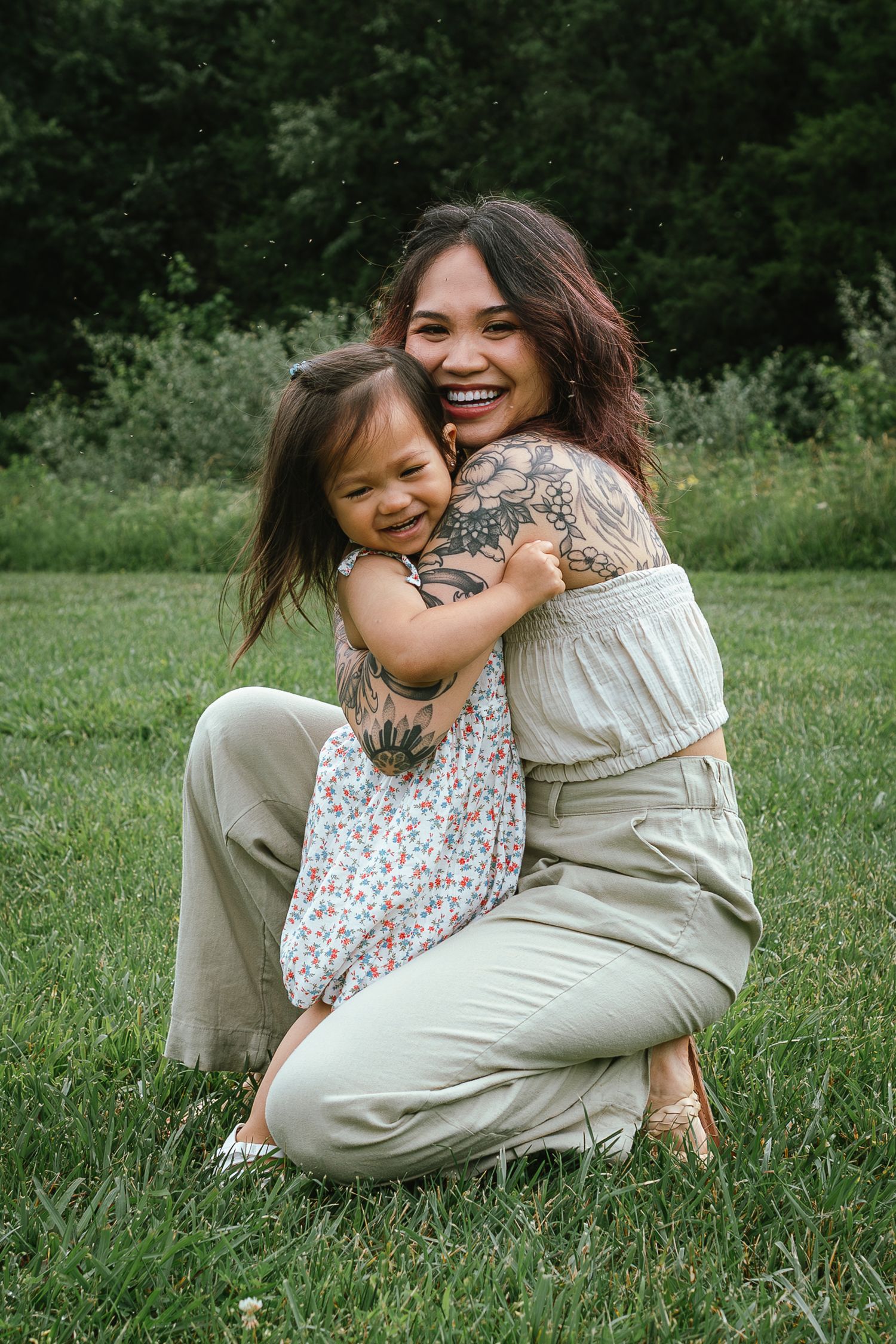 Candid moments of joy and laughter shared between two people playing in a sunny field.