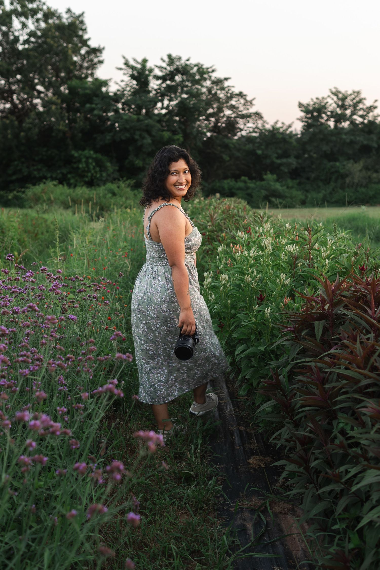 Summer evening portrait among wildflowers and garden plants with soft natural lighting.