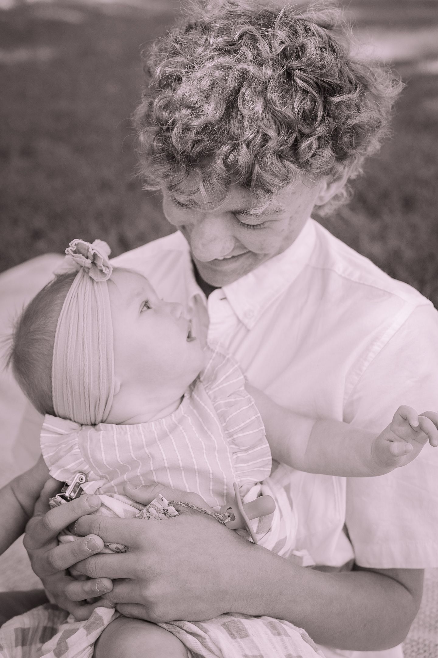 A sweet black and white portrait showing a tender moment between two people.