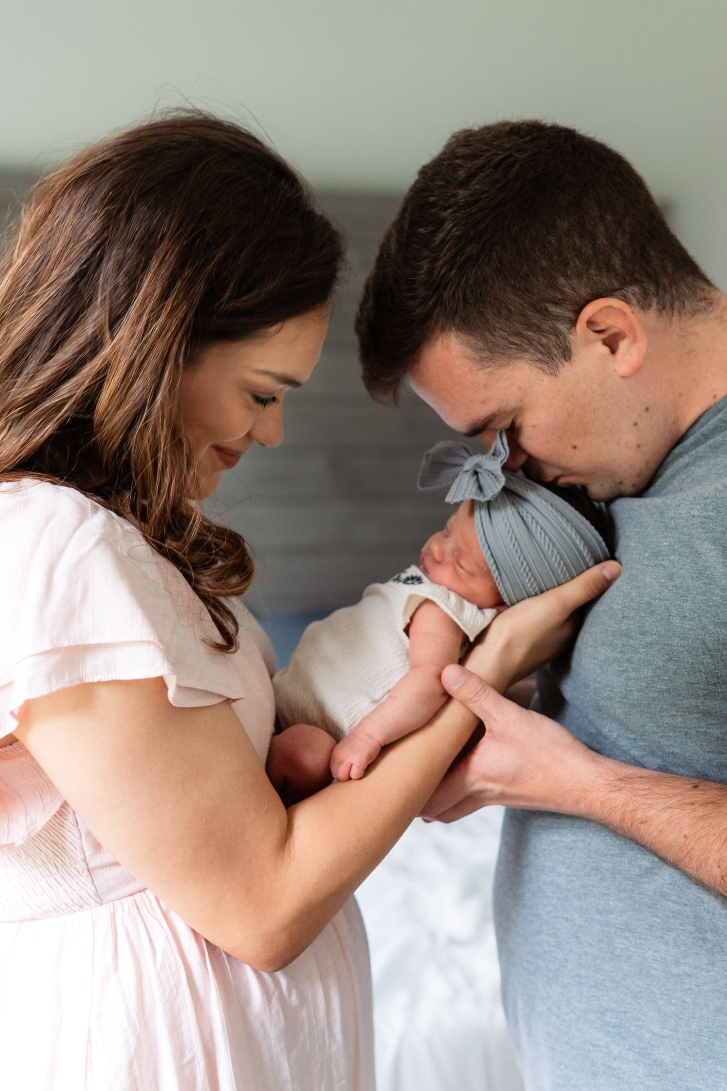 Series showing tender family moments with new baby in soft lighting.