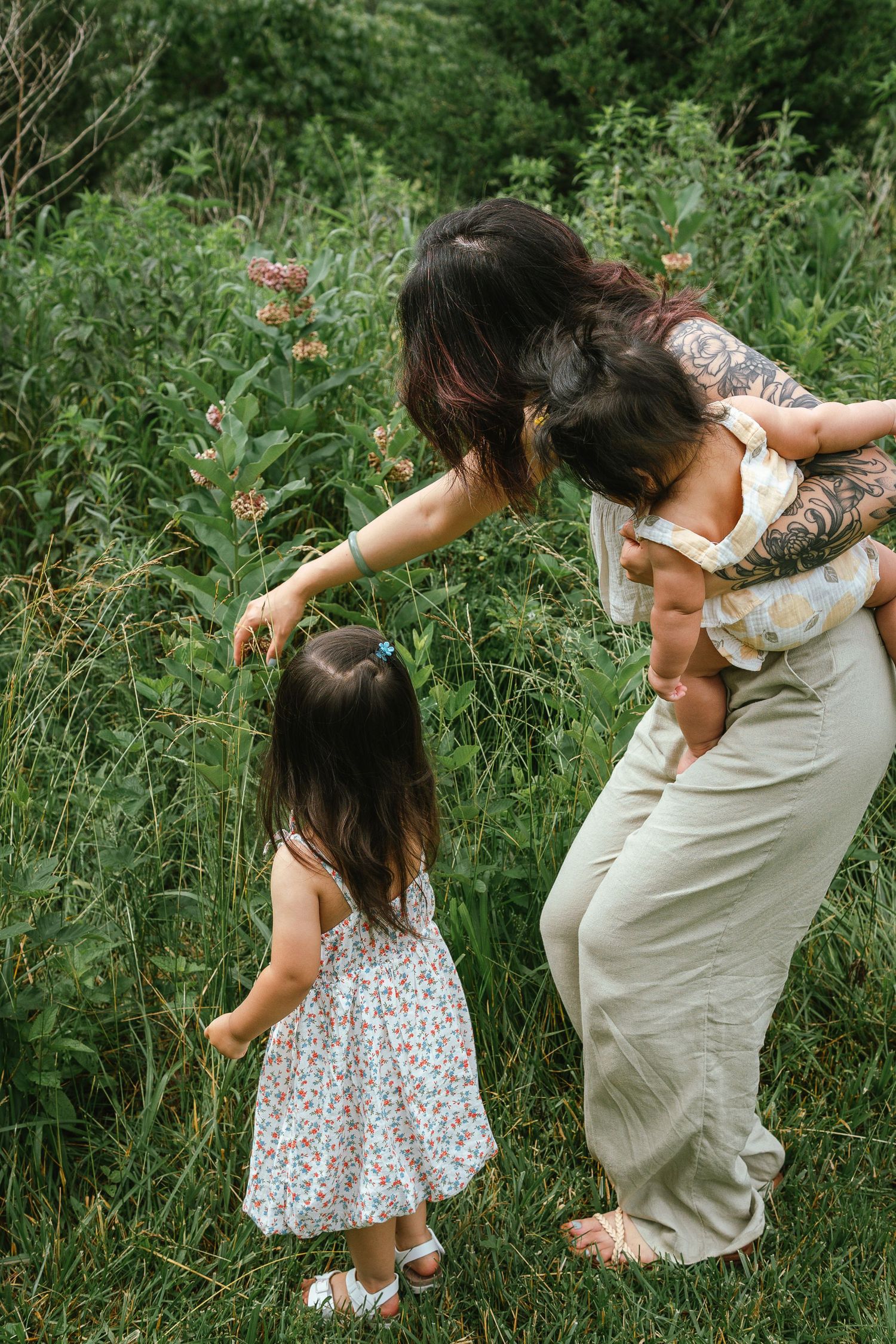 Dynamic outdoor photoshoot captures playful moments between parent and child in a natural setting.