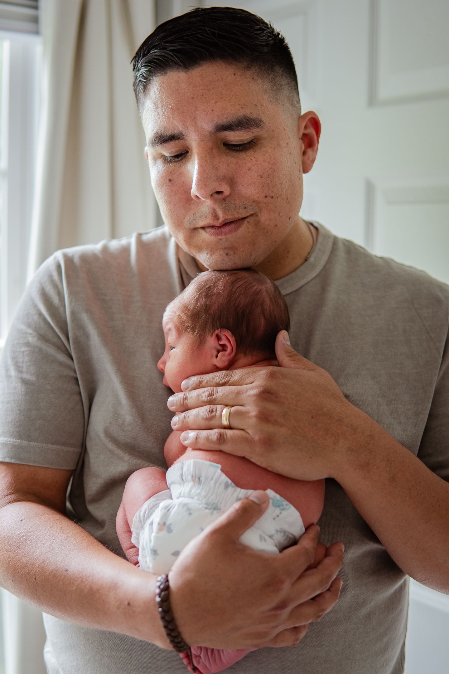 Collection of candid moments showing parent cradling and bonding with newborn baby.