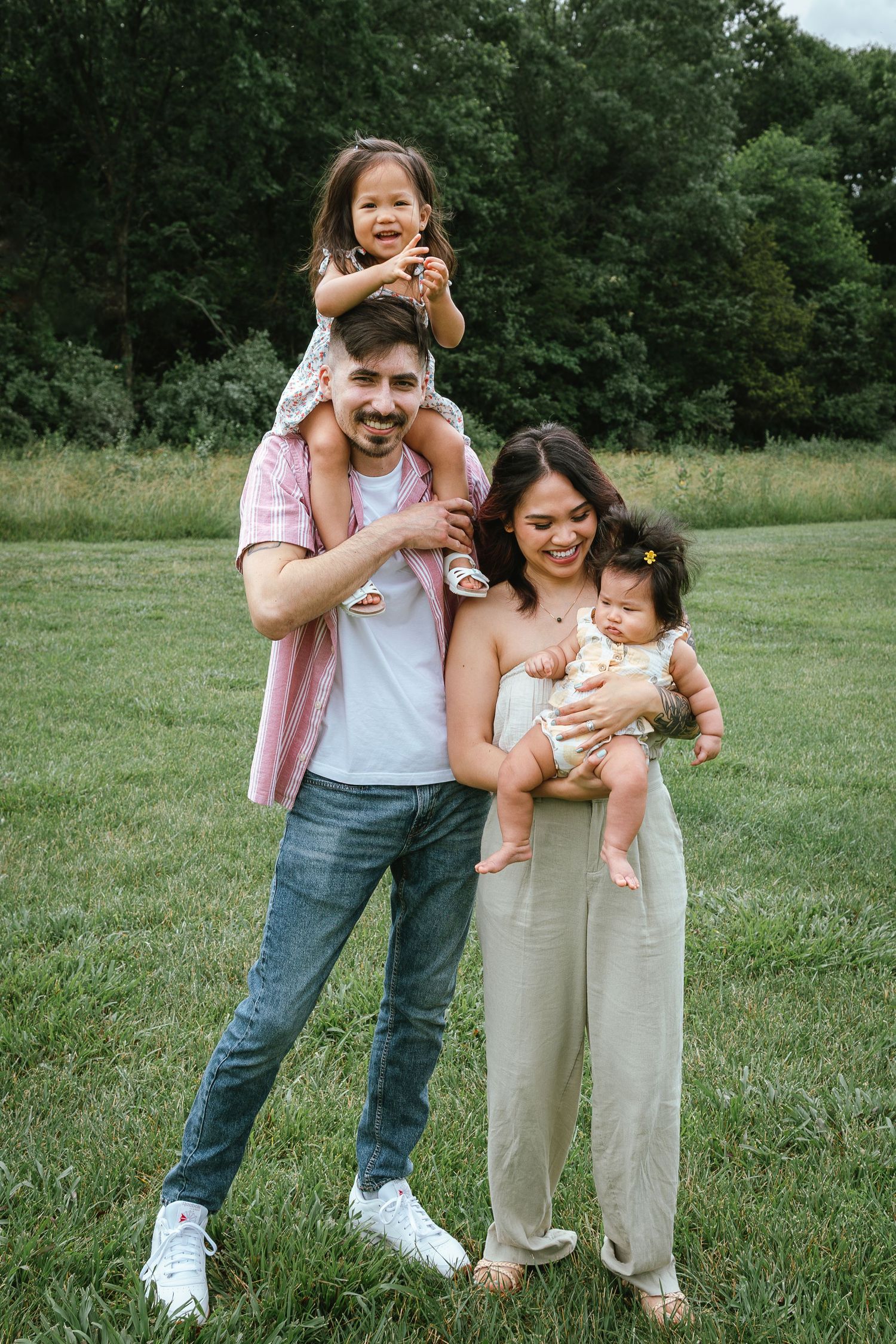 Candid family moments captured in a park setting with natural expressions and laughter.