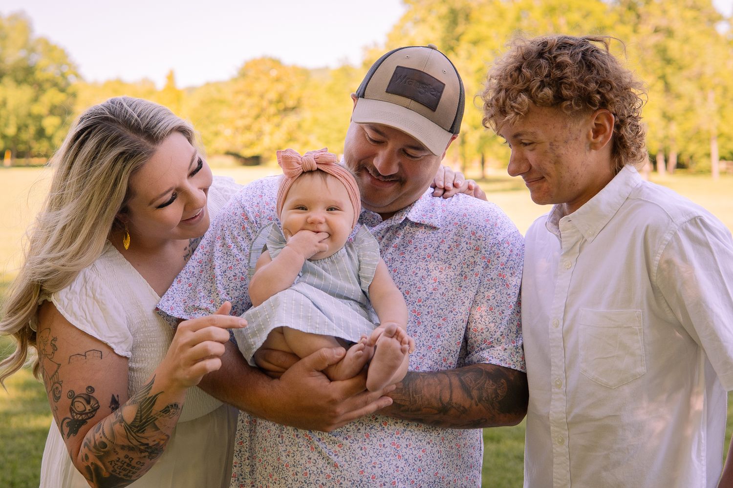 A happy family spending time together outdoors in a sun-drenched park during golden hour.