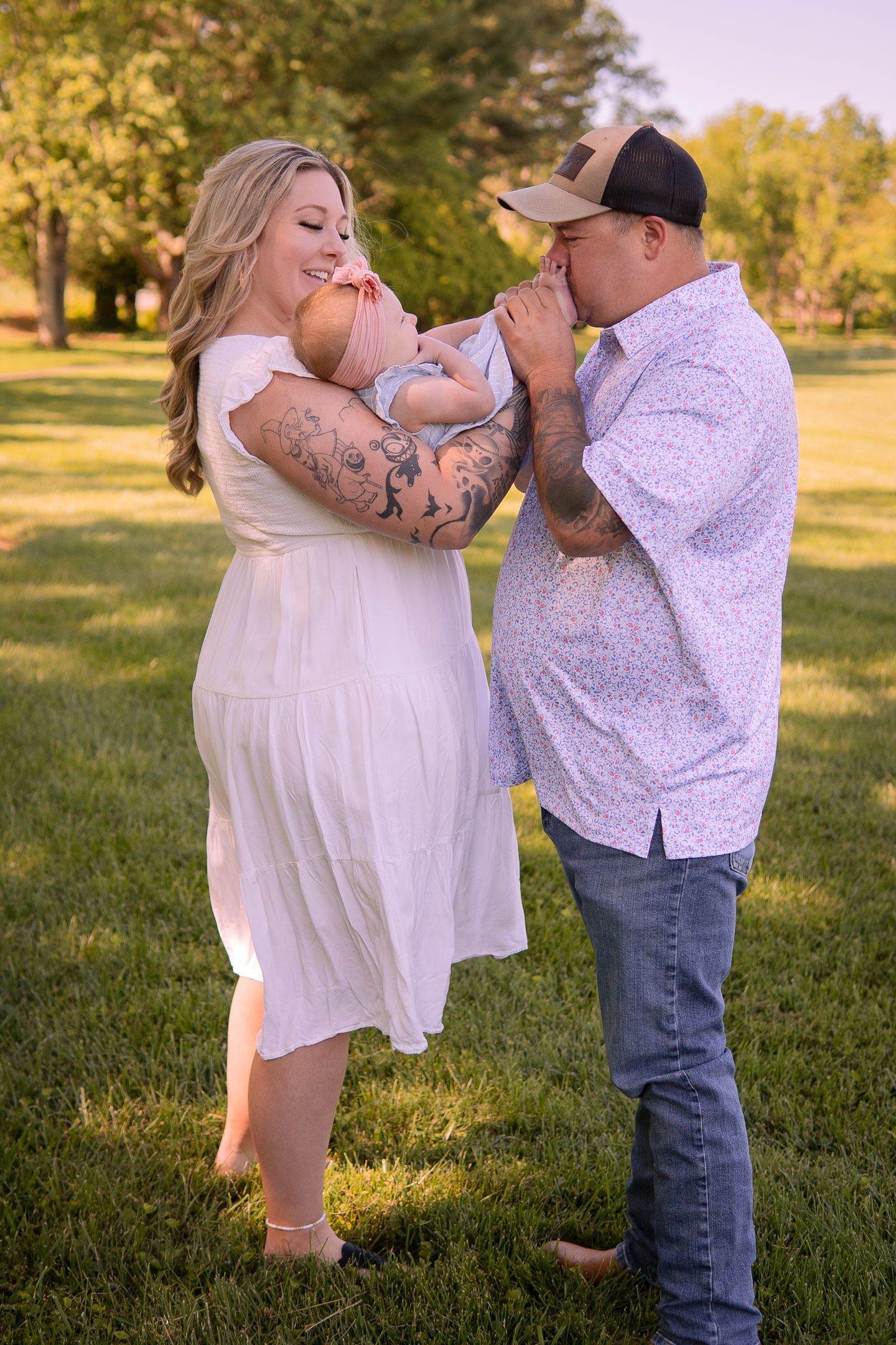 Family group shares playful moments together in outdoor setting with autumn lighting.