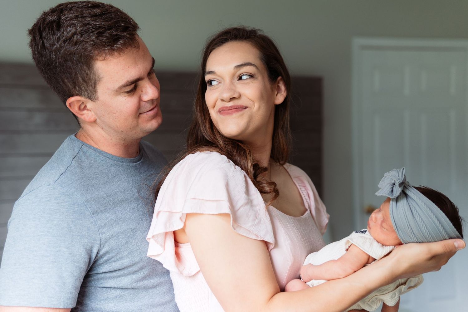 Family photo series showing loving interactions against a gray wall background.