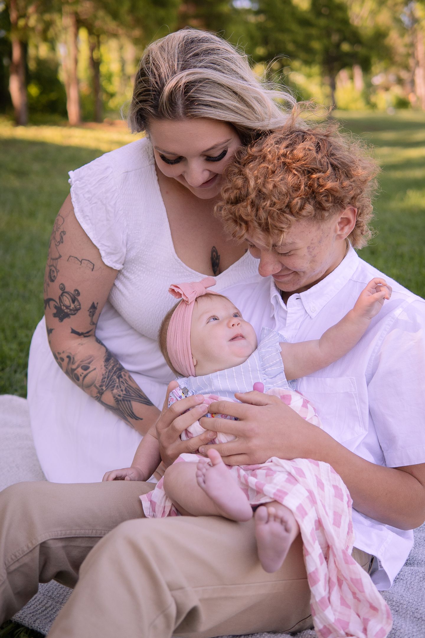 Intimate family moments captured with baby on blanket outdoors in natural lighting.
