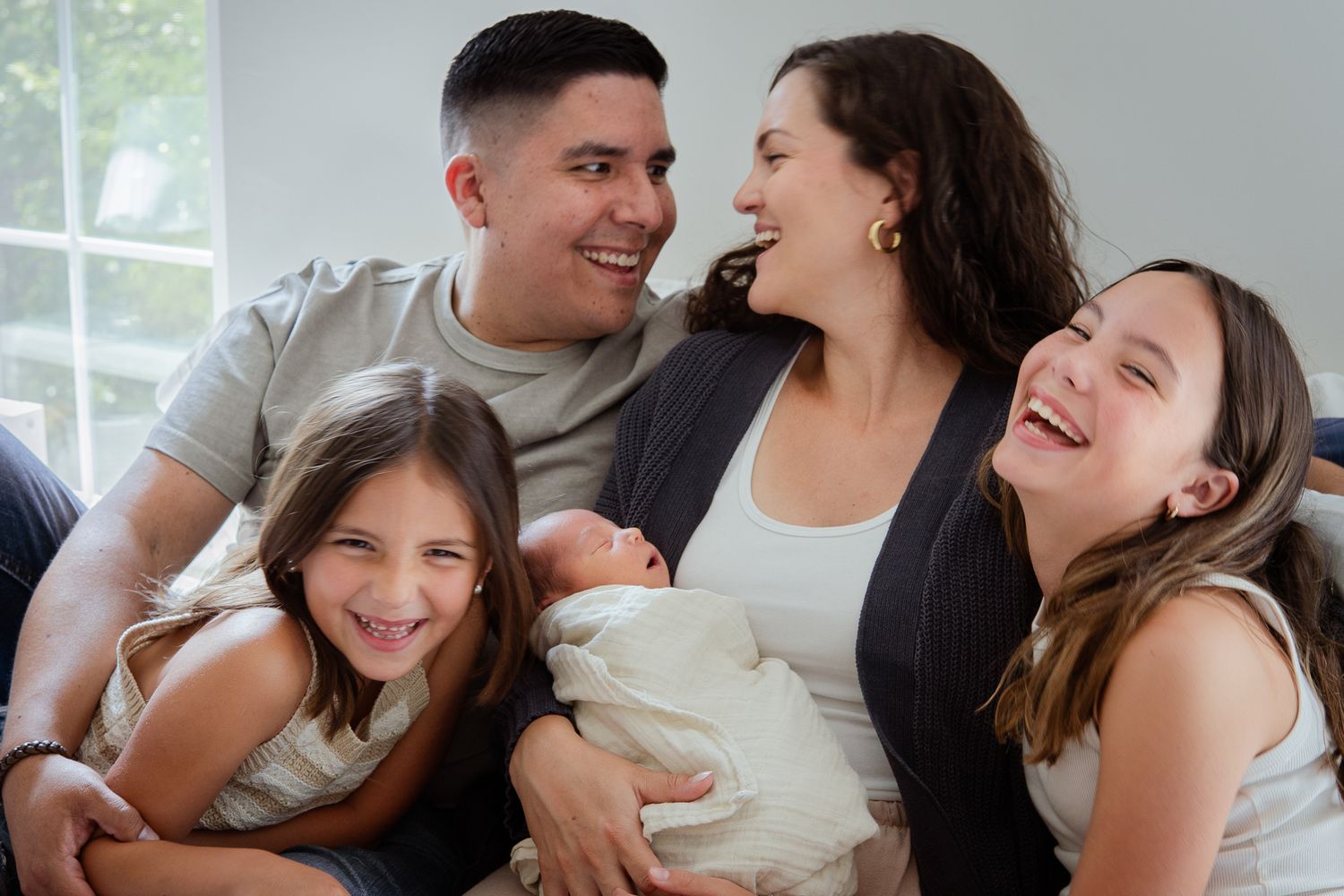 Joyful family moment captured in natural light showing closeness and laughter.