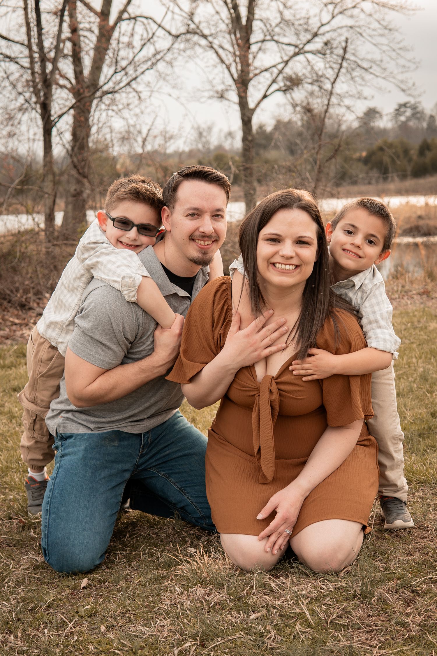 Four candid outdoor maternity photos show a couple sitting together in a natural setting during golden hour.