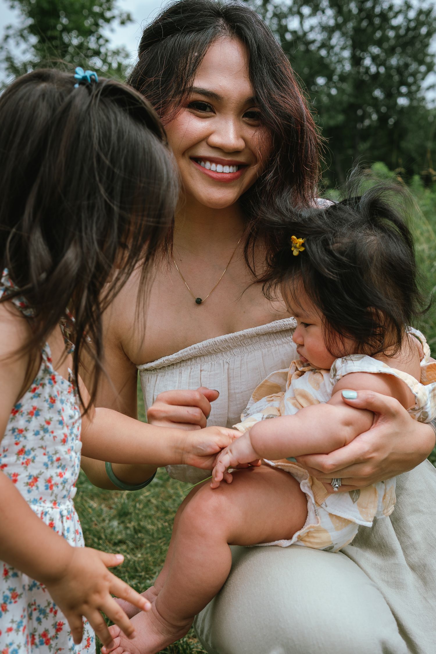 A joyful outdoor moment shared between family members on a sunny day in a park setting.