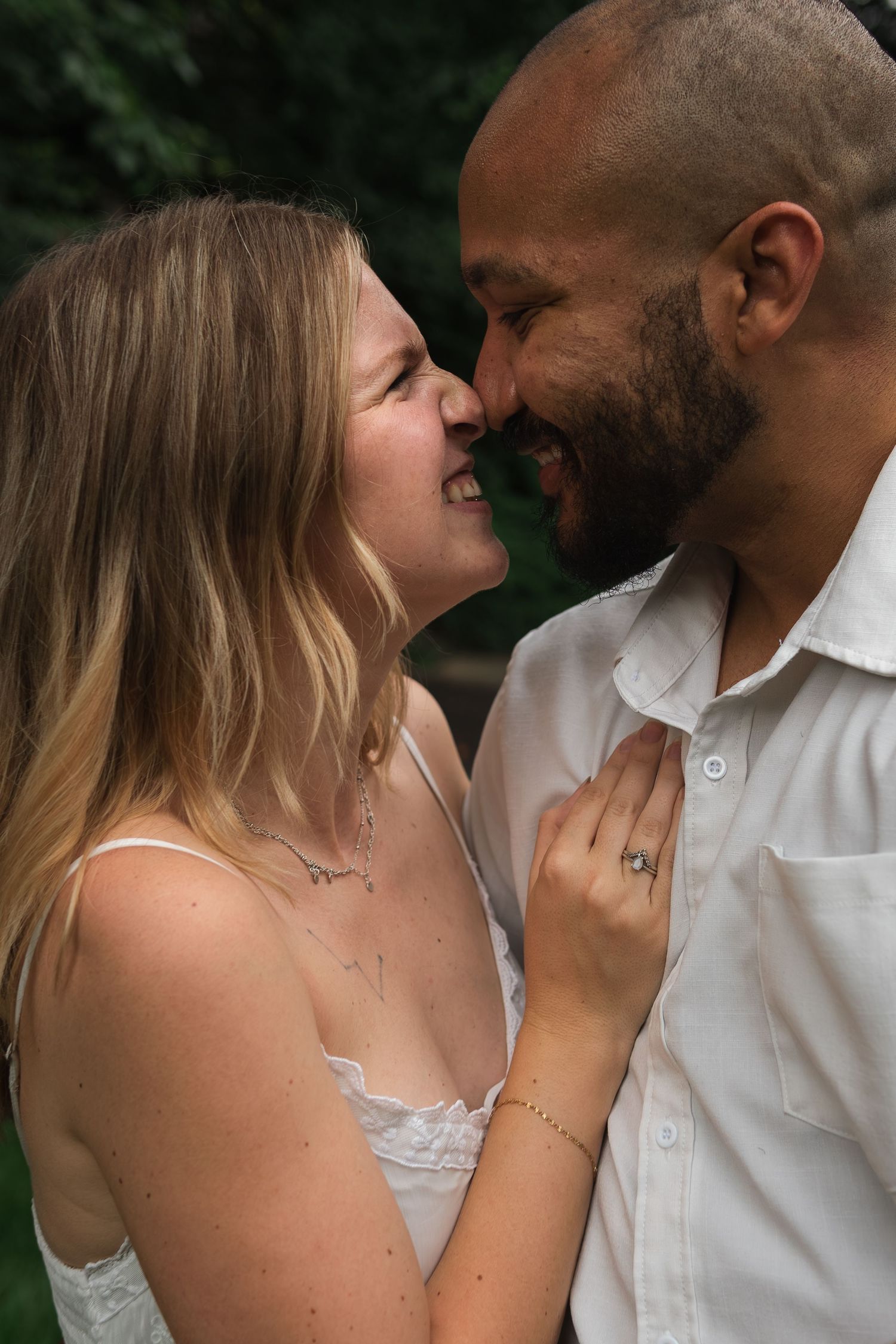An intimate series of close-up shots shows a couple in white clothing sharing tender moments together.