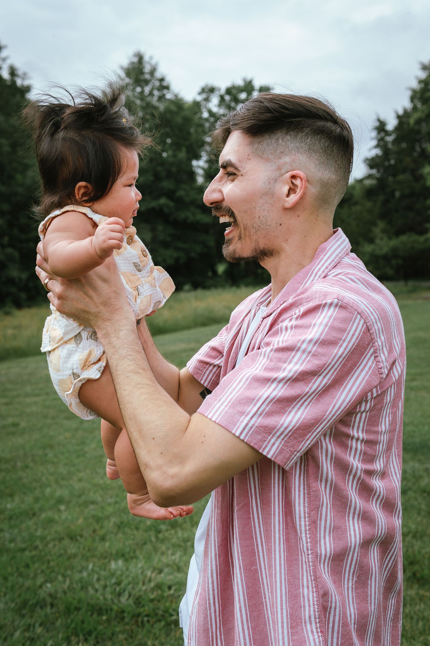 Playful interaction sequence with pink striped shirt against green outdoor setting.