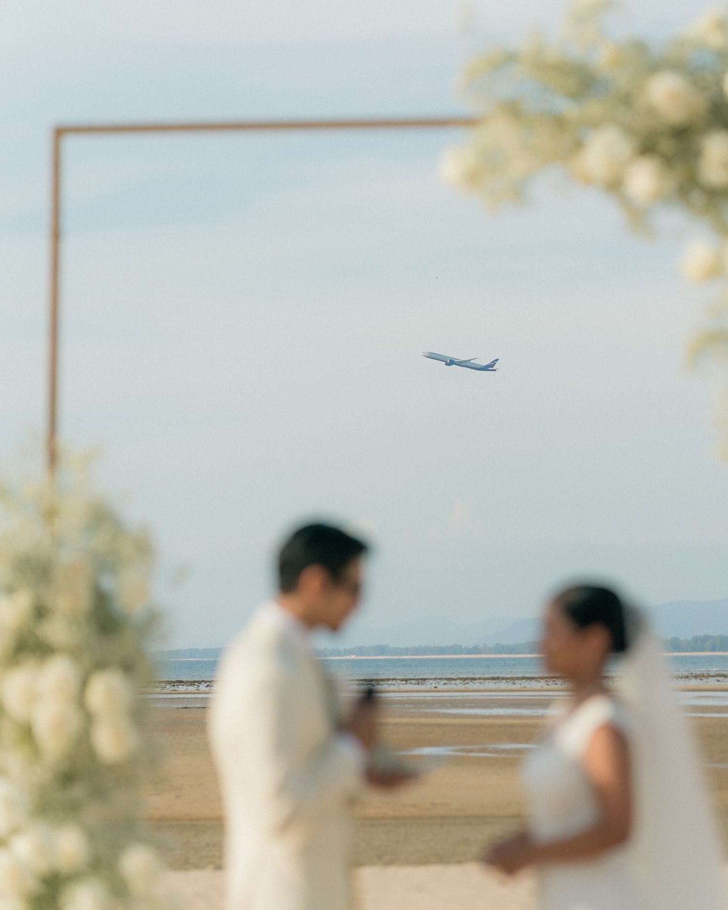 Wedding ceremony at Phuket Marriott Naiyang beach, Amazing photo during vows exchange have the airplane takeoff in the background nice shot
