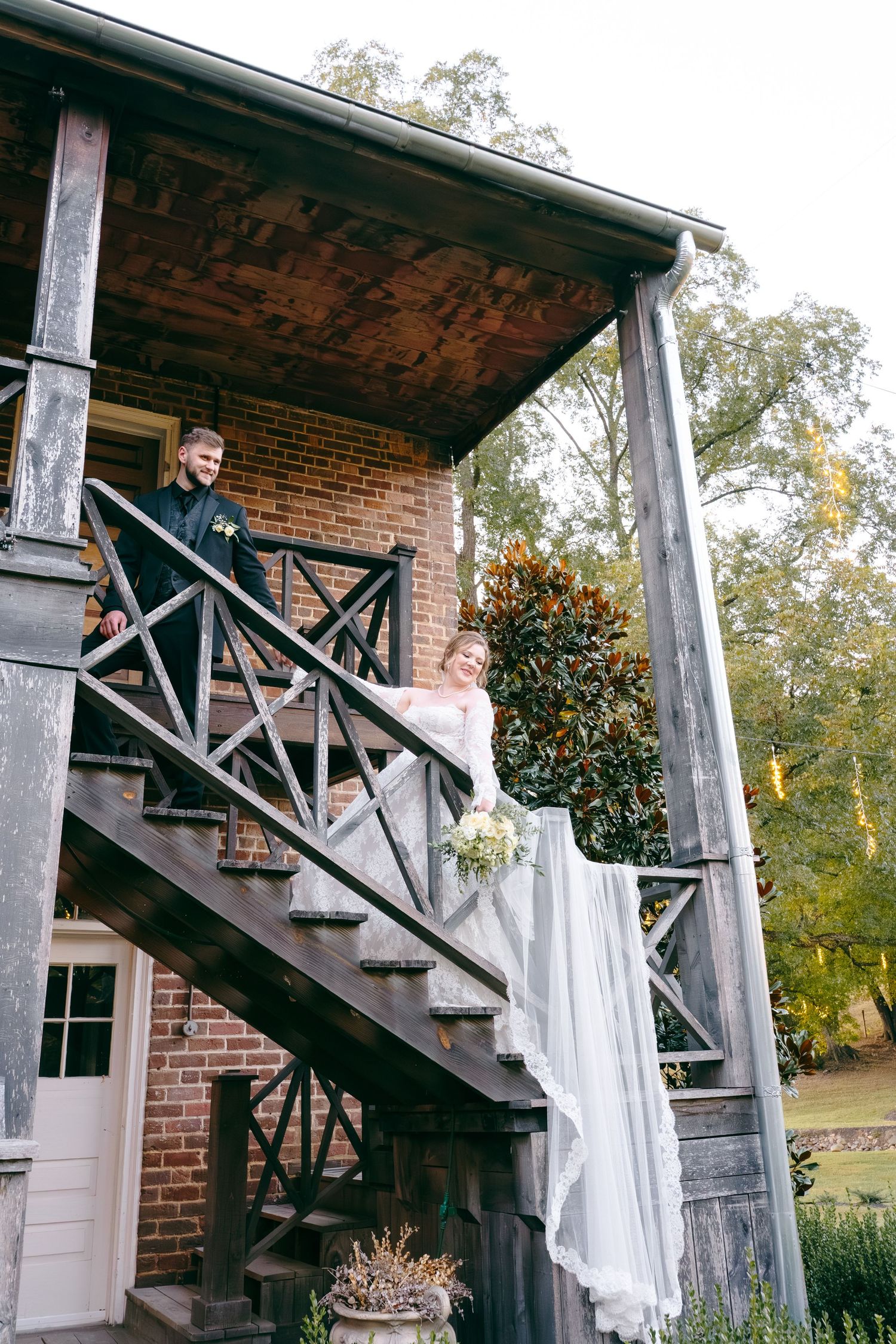 Wedding photo sequence on rustic wooden stairs with white fabric decorations.