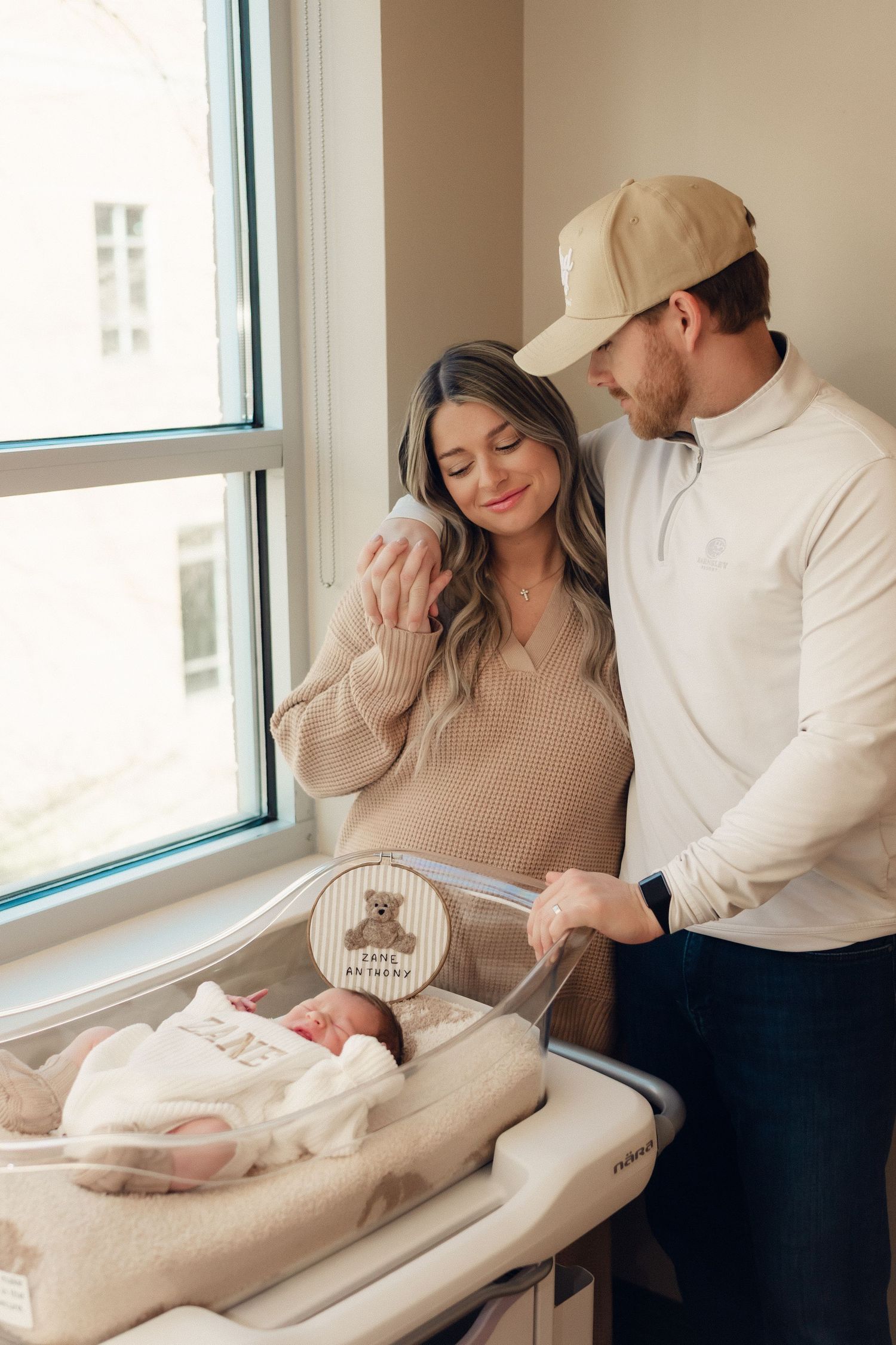 Series of lifestyle photos showing parents bonding with newborn by window in neutral tones.