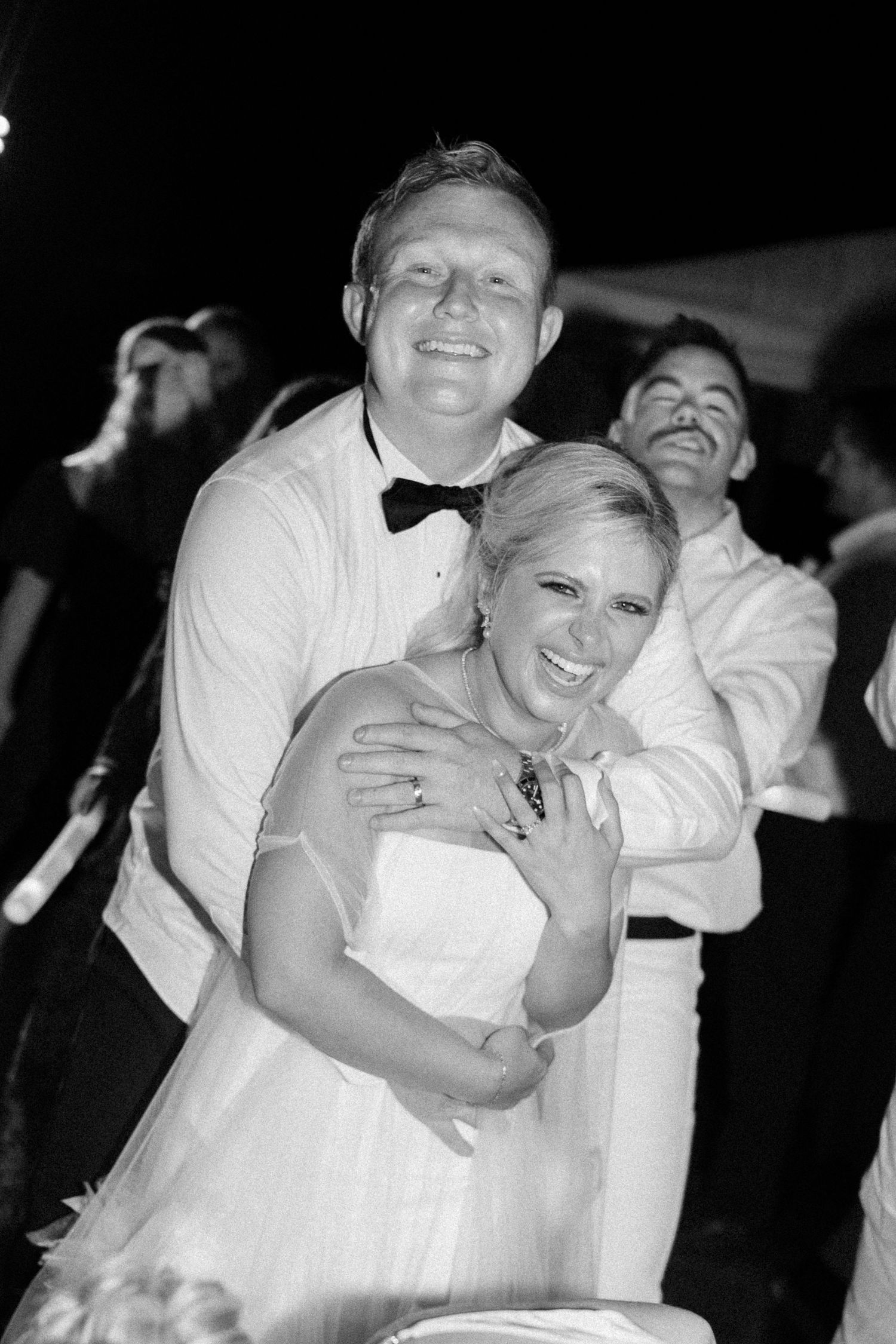 Happy couple shares joyful dance moves at their wedding reception celebration.