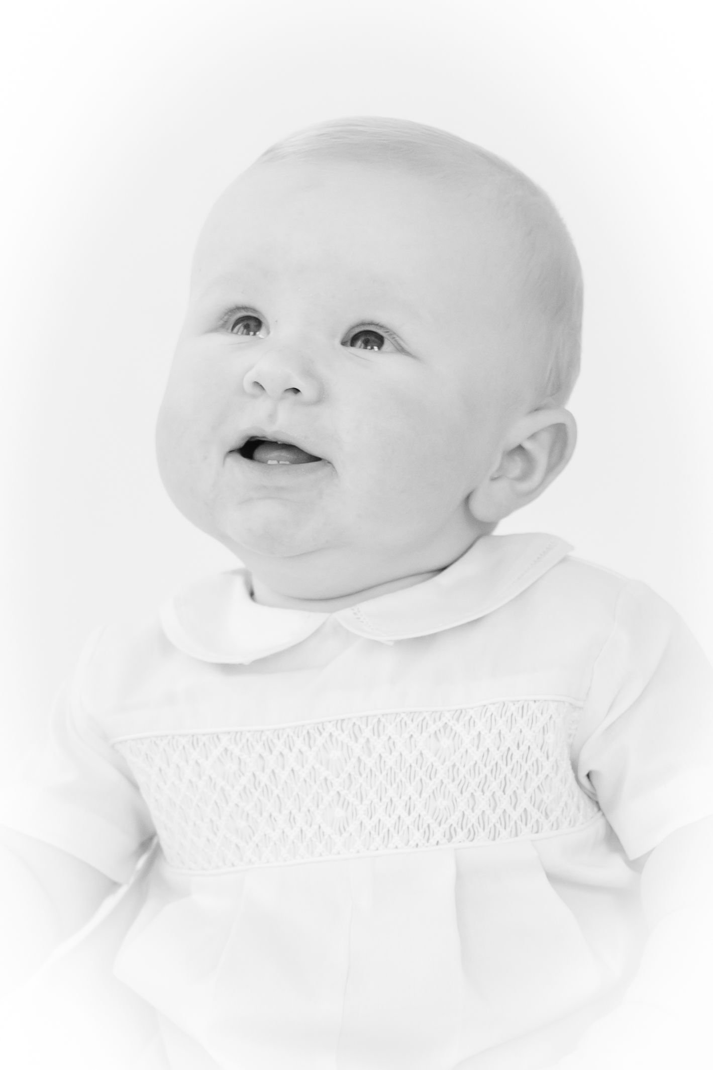 Black and white series showing a baby's expressions and smiles against white background.