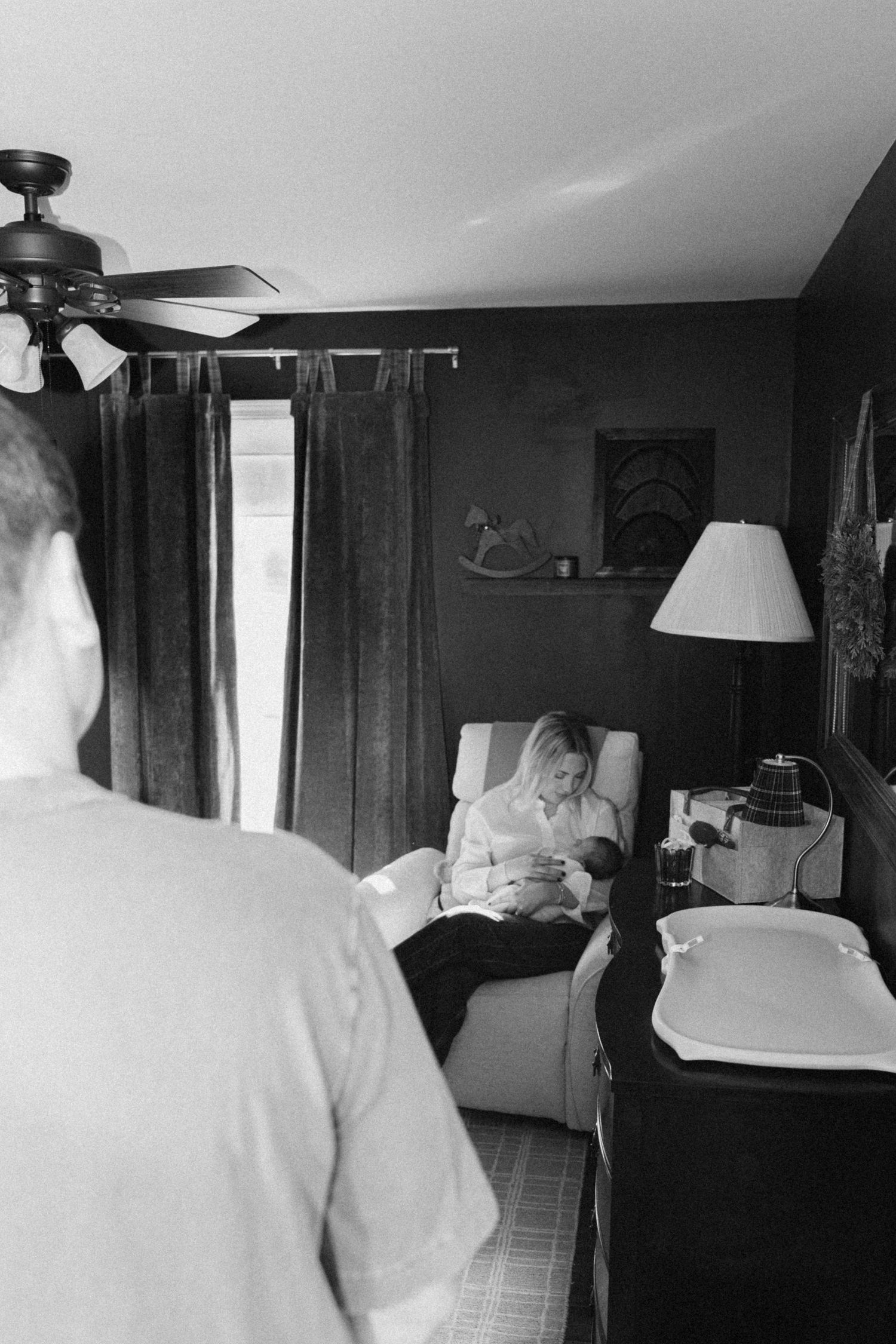 A series of black and white photos showing a nursery room with a crib and window.