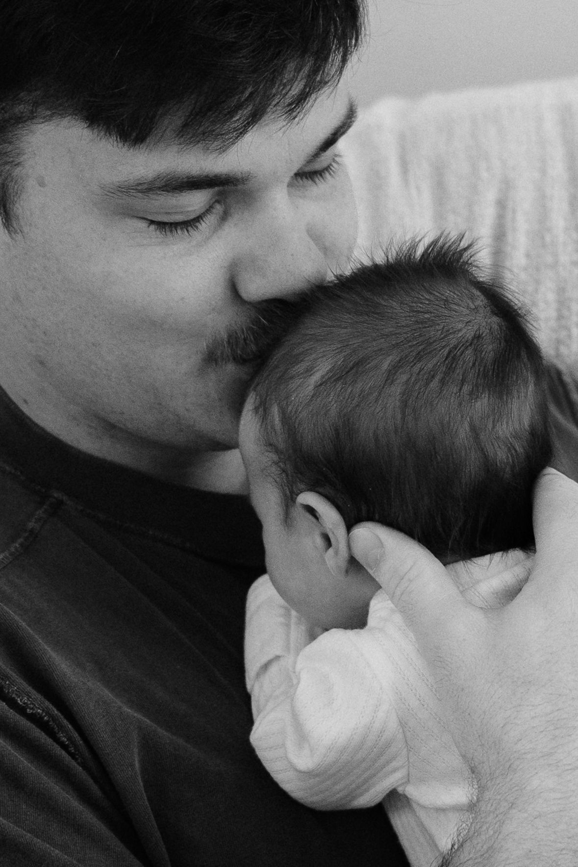 Tender black and white newborn photography moments.