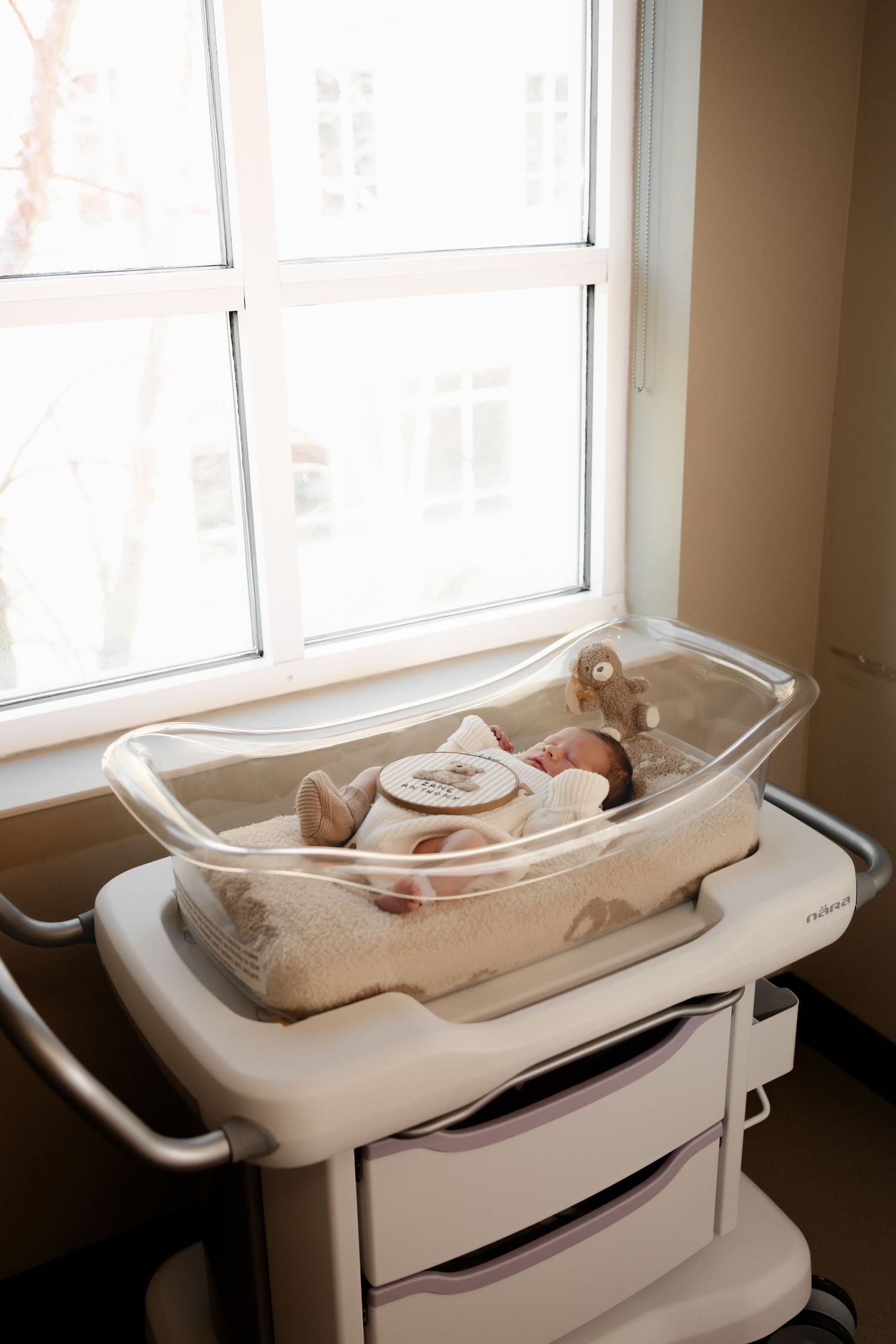 A series of photos showing a white baby changing station mounted on a wall next to a window.