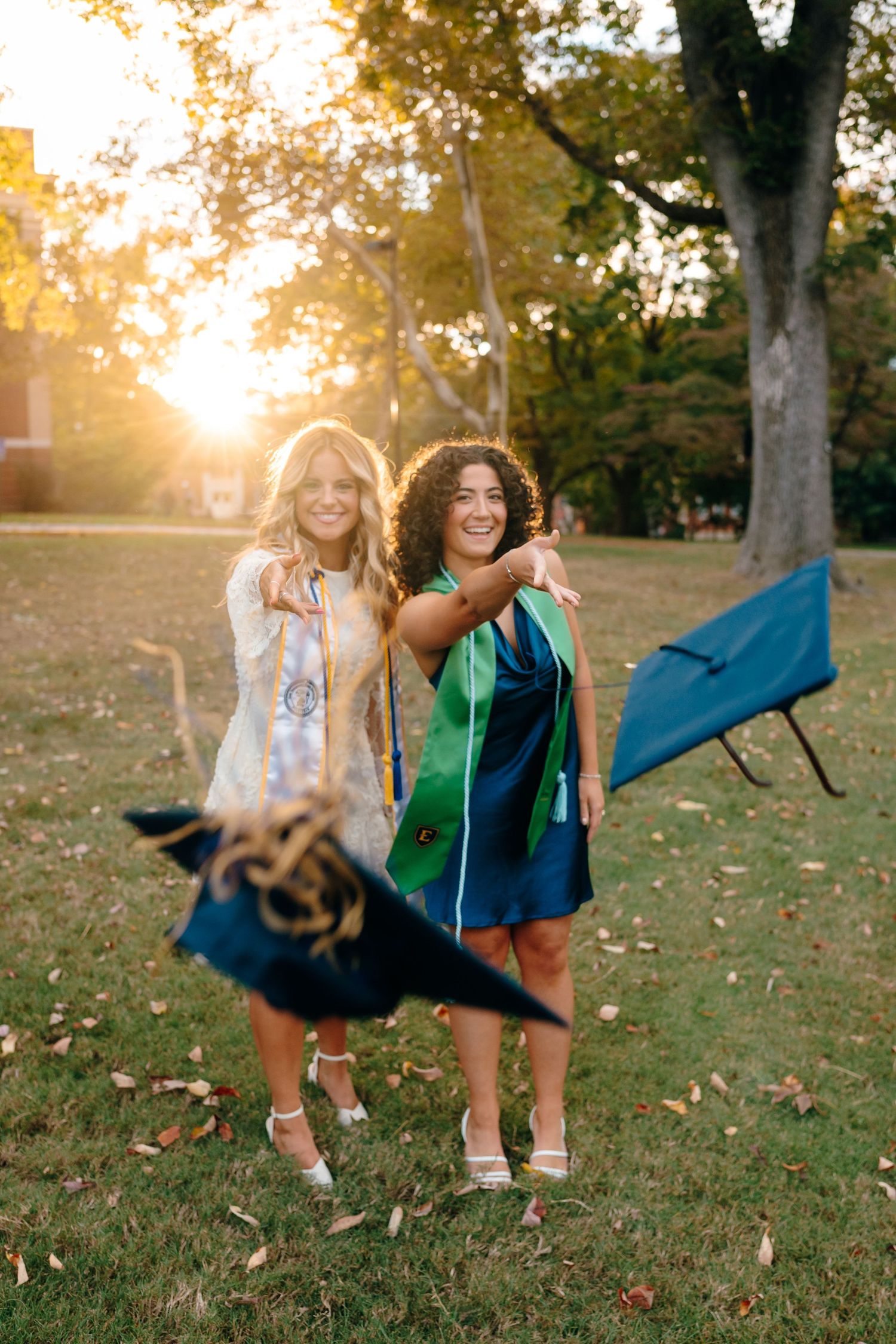 Playful autumn photo shoot on grass with friends in casual athletic wear.