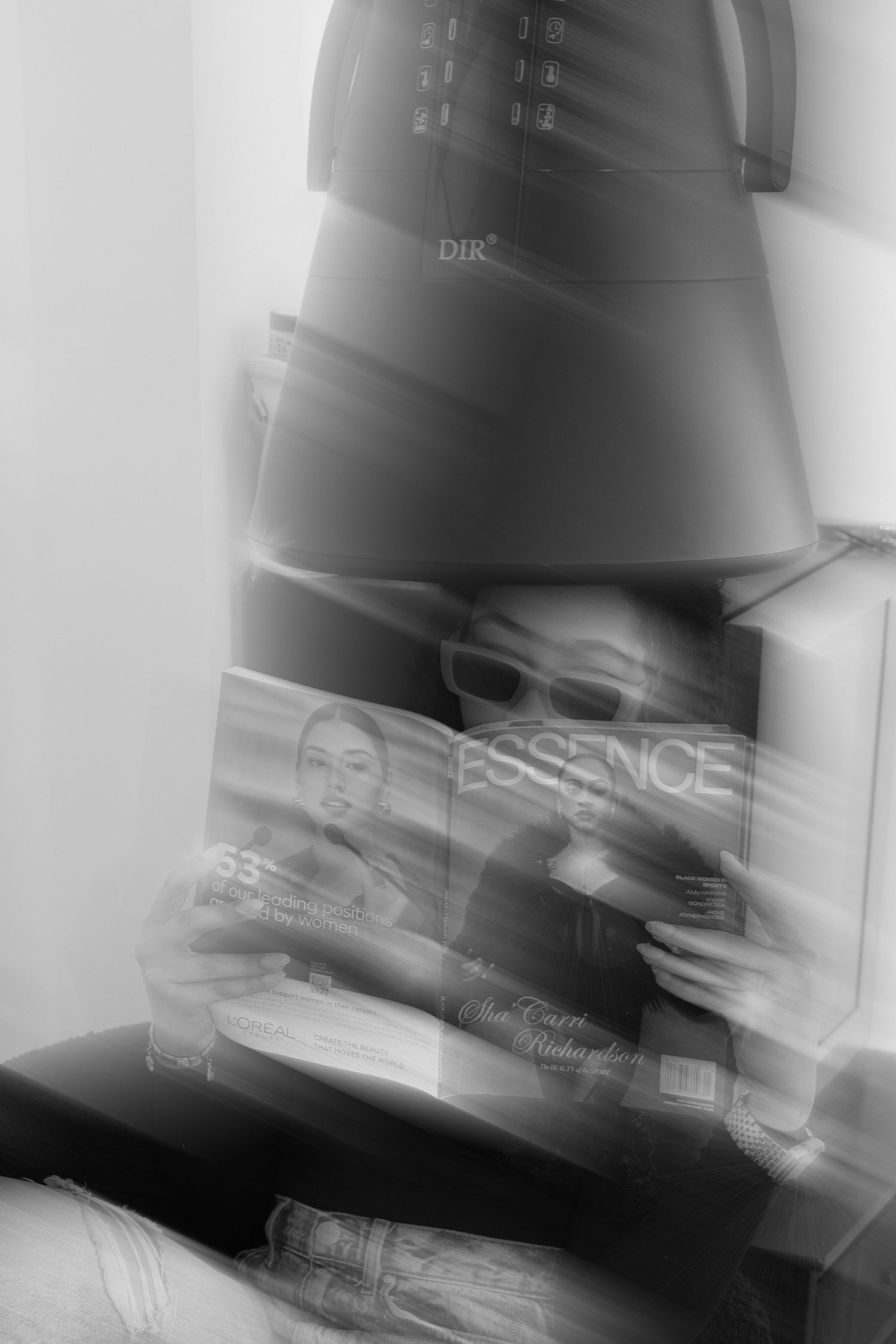 Blurred motion abstract of black and white shapes creating a dynamic diagonal composition.