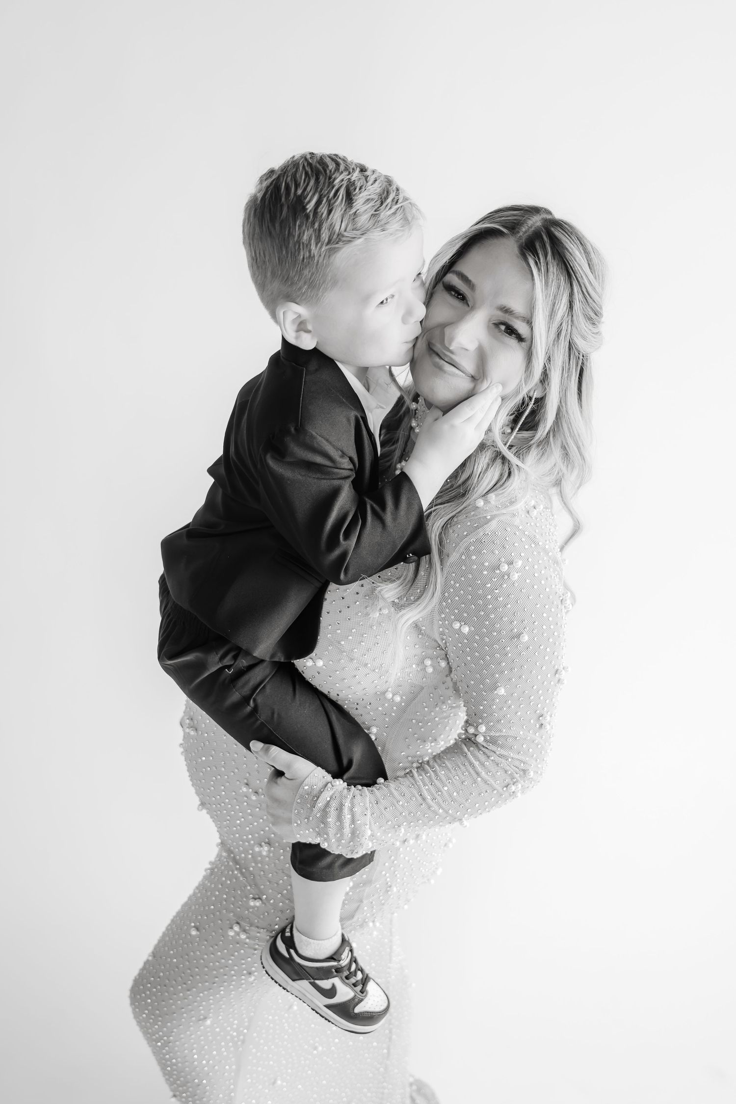 Intimate black and white maternity photos showing tender moments between mother and child.