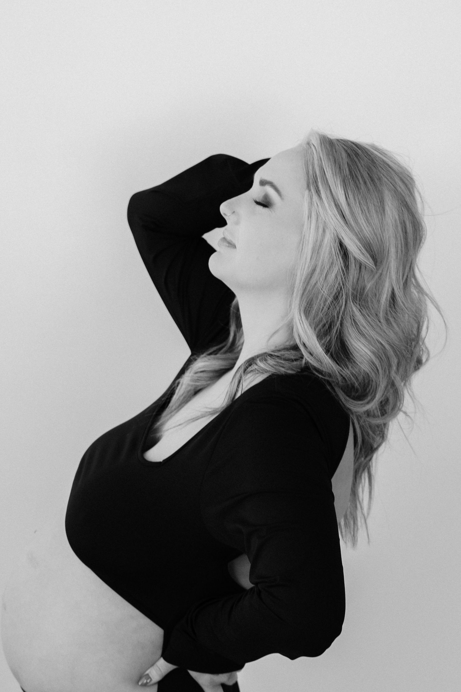 Black and white portrait series showing dramatic poses in a black top.