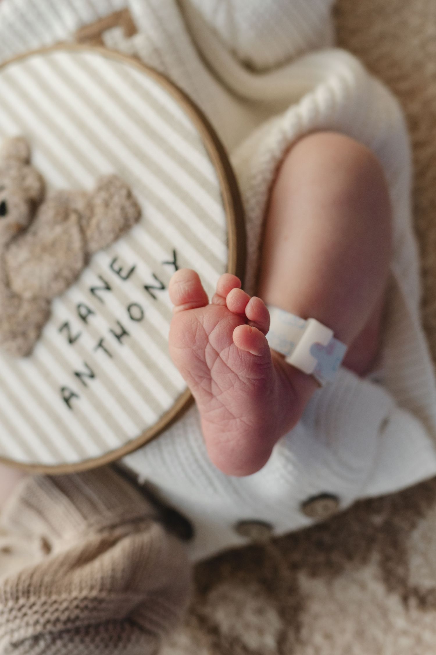 Close-up series of tiny newborn baby feet resting on textured paper with text.