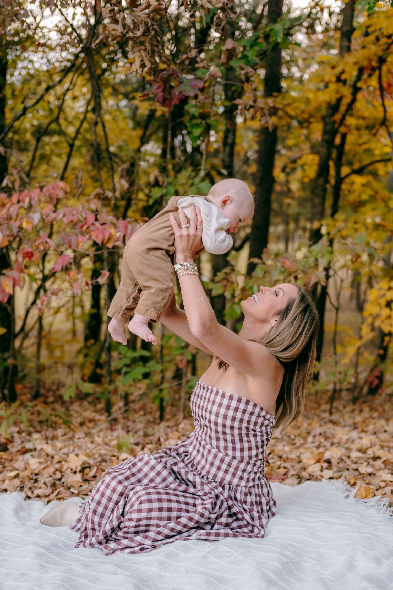 Fall outdoor scene with checkered blanket and autumn foliage.