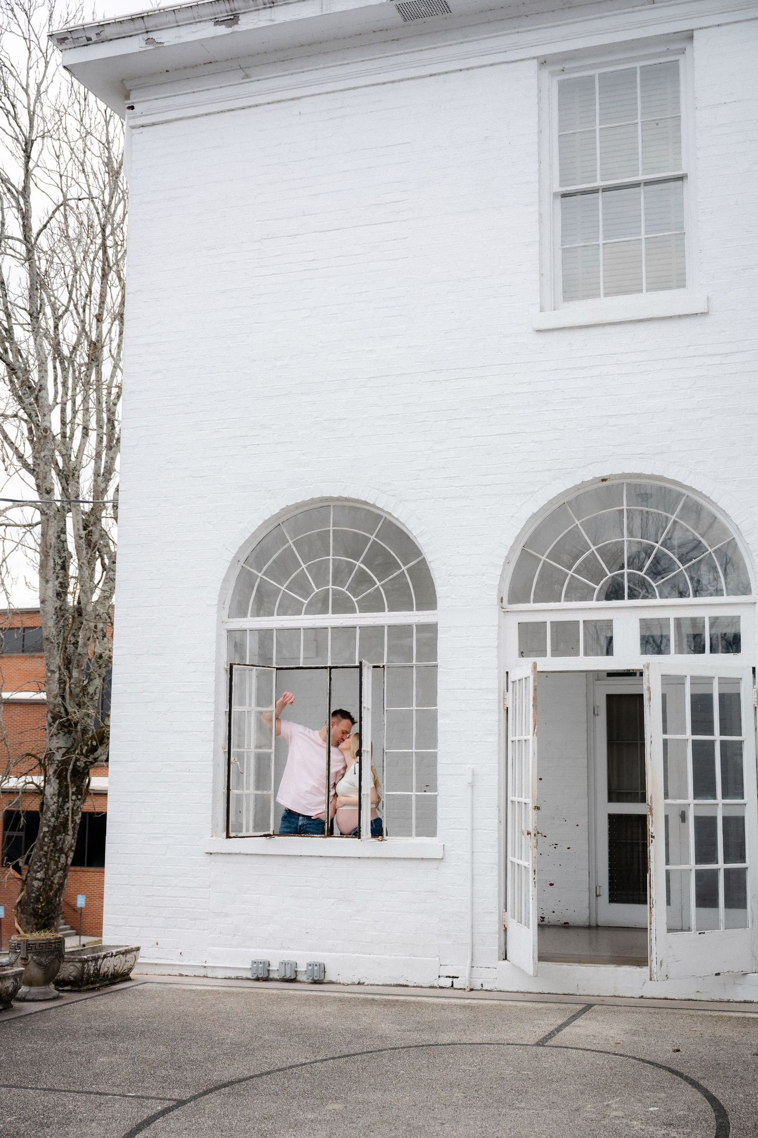 White building exterior with arched windows and elegant architectural details.