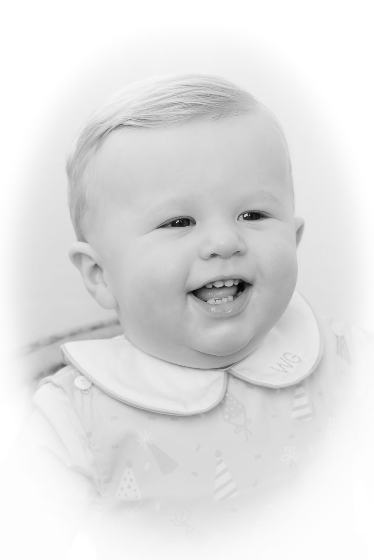 Four sweet expressions of a baby wearing a white bib shown in a soft, dreamy style collage.