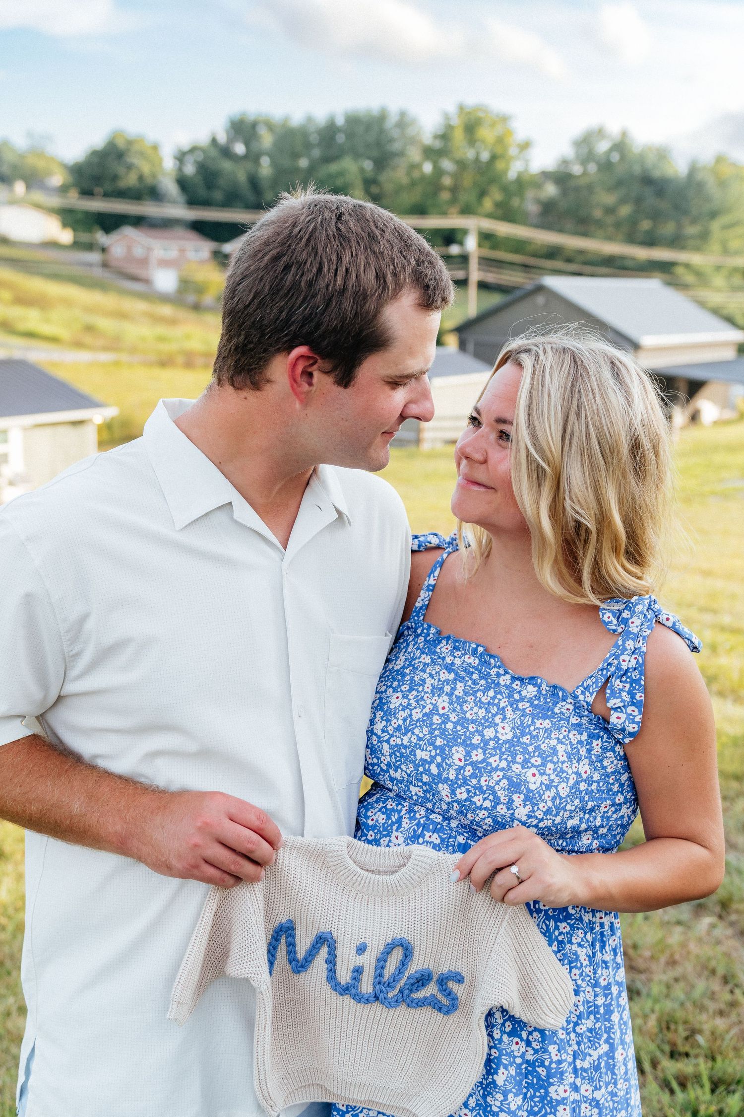 Outdoor couple photos displaying knit baby announcement sweater.
