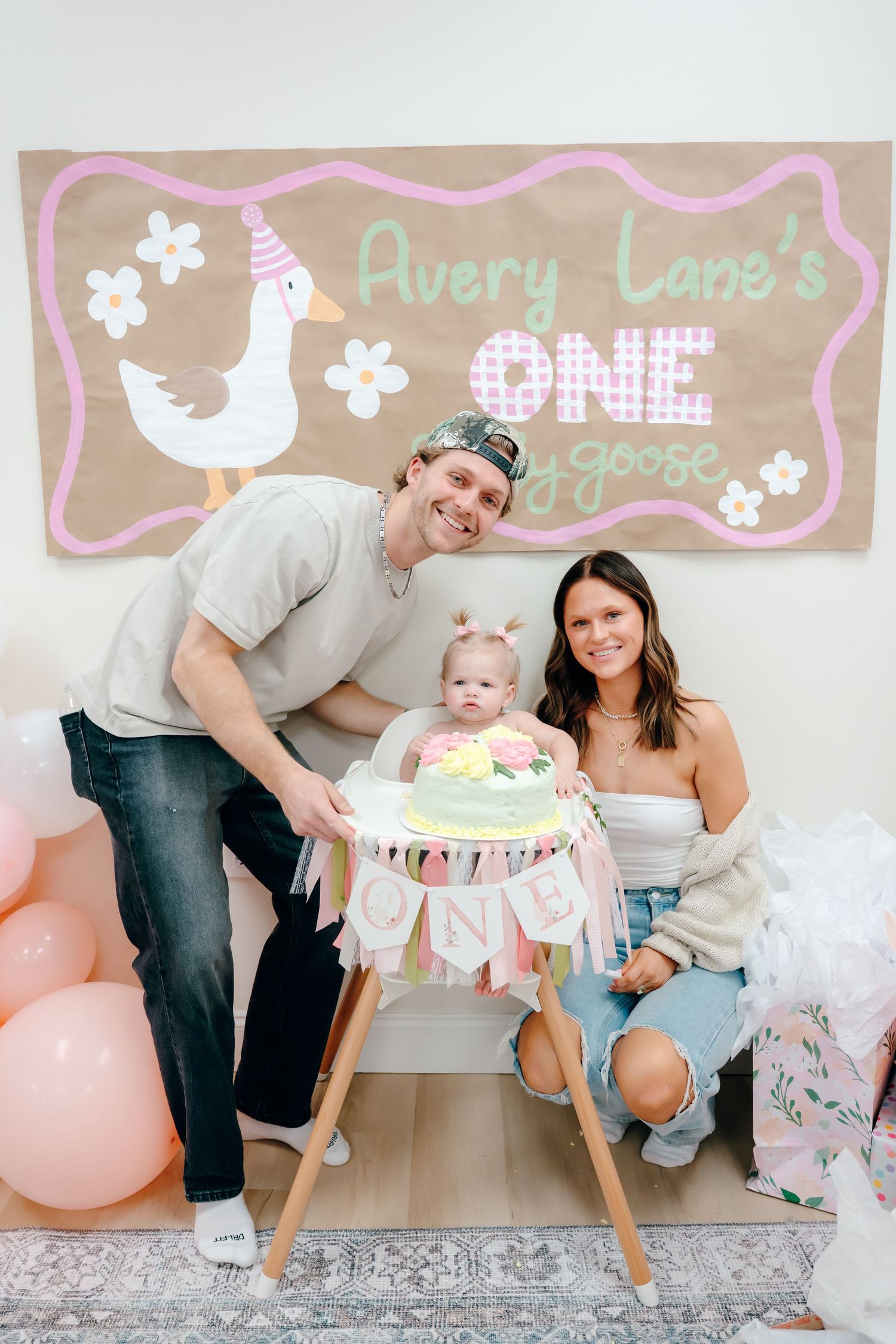 First birthday party celebration with rustic decor and pink accents.
