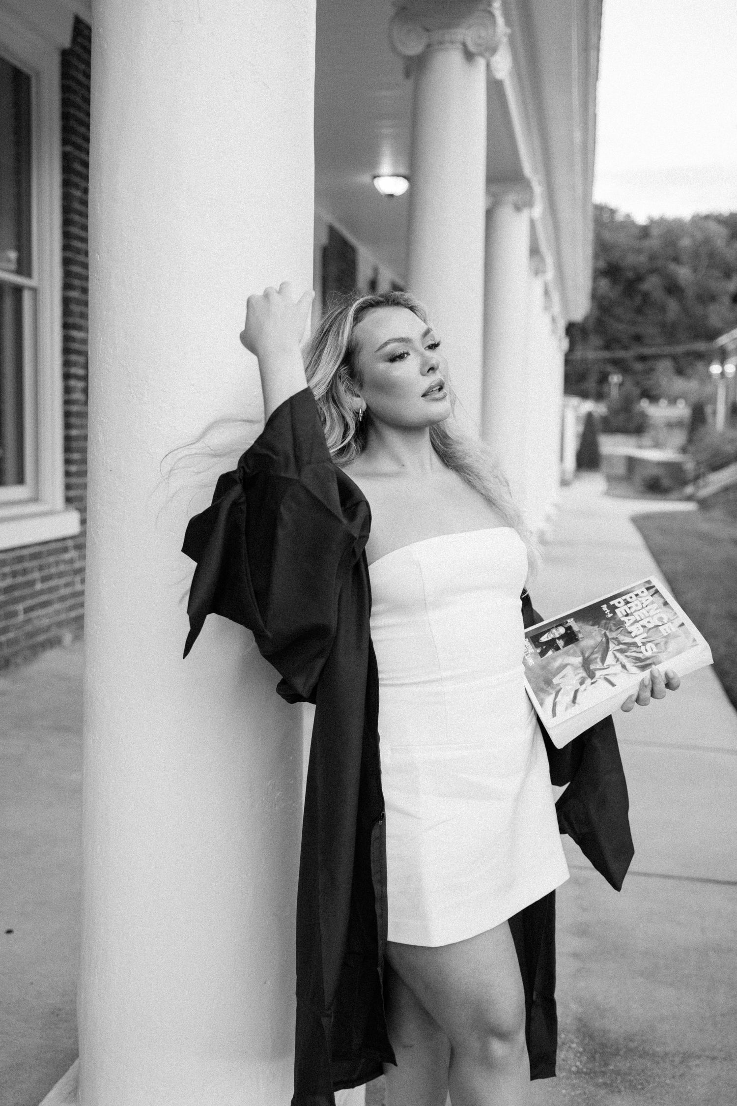 Artistic black and white graduation portraits taken against architectural columns.