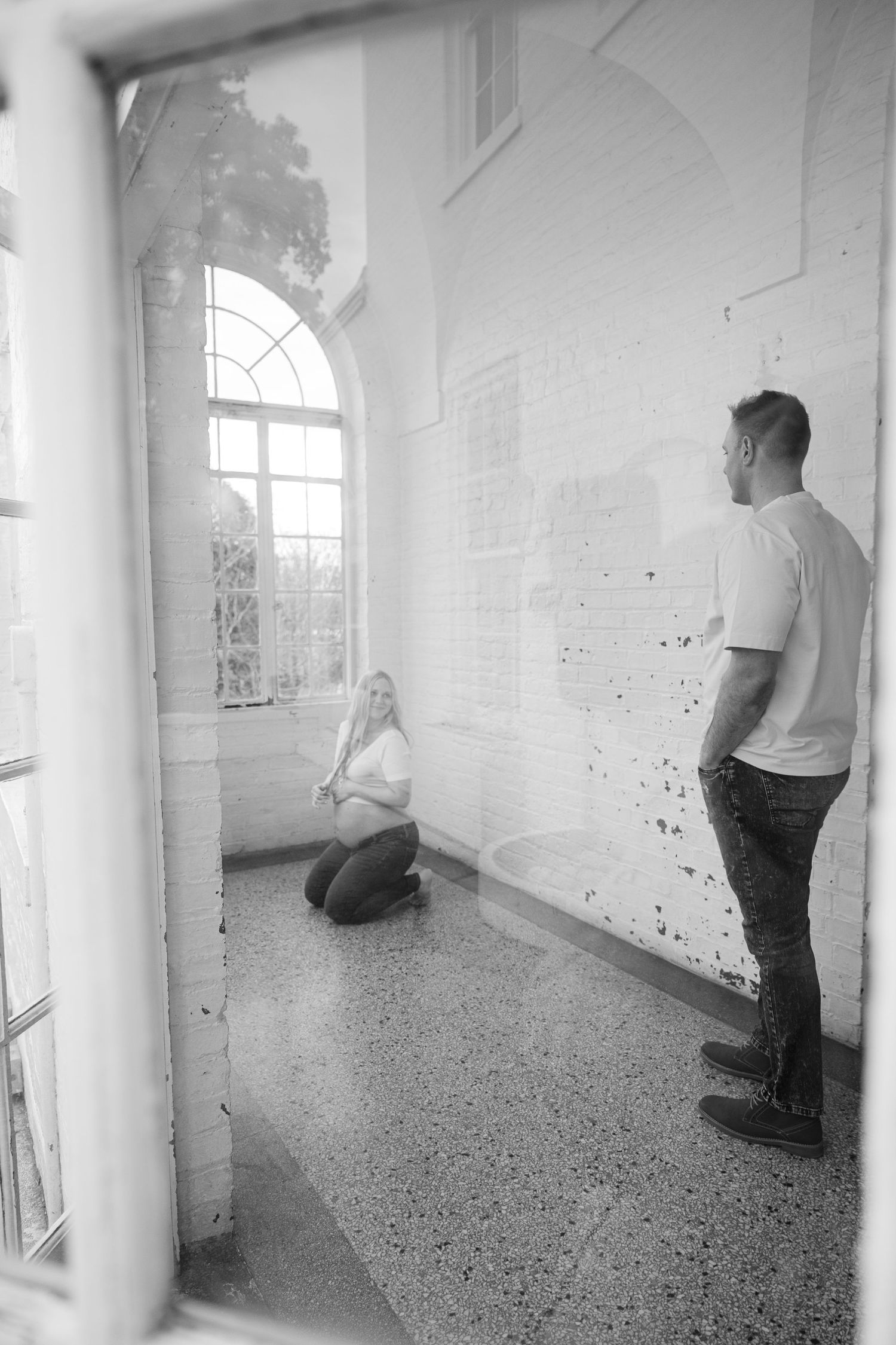Black and white artistic photos in minimalist white interior space.
