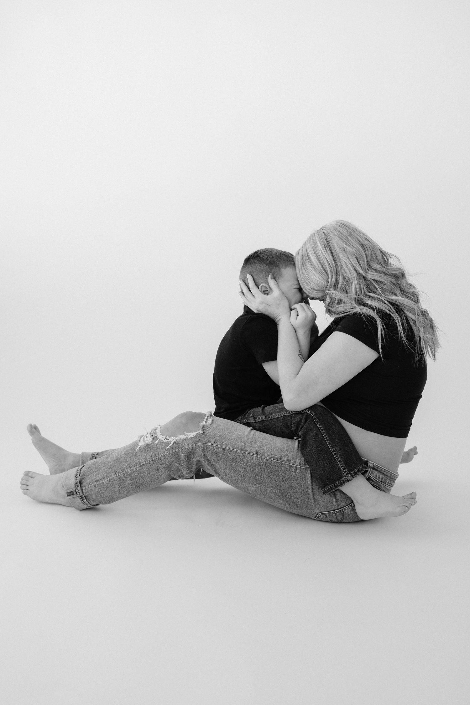 Black and white artistic maternity poses on a white background showing reclining positions.