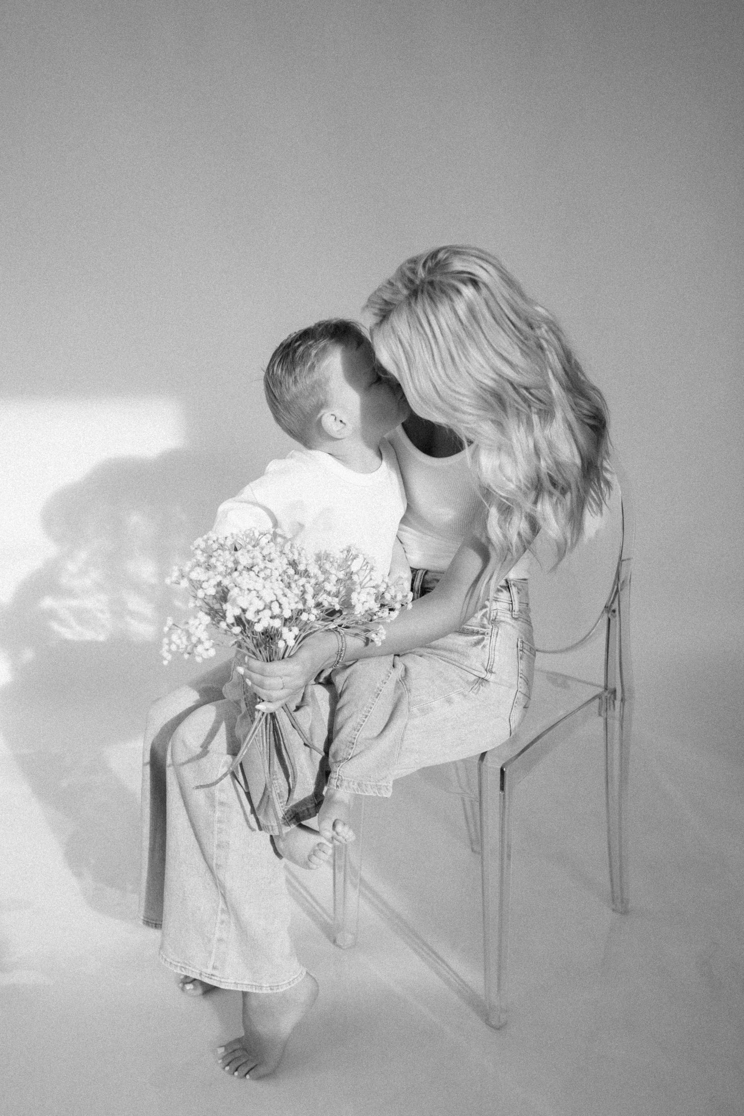 Black and white artistic sequence showing a person leaning over a chair with a bouquet of flowers.