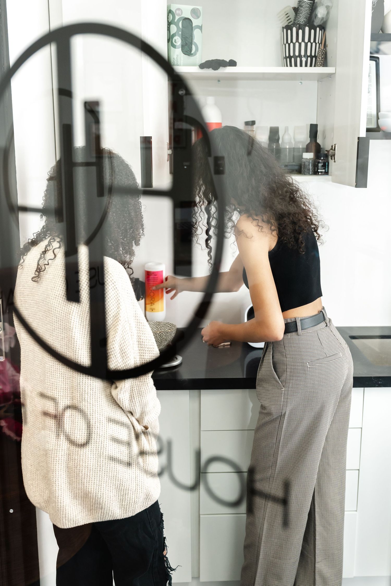 A series of black and white photos showing someone in casual attire moving through an interior space.